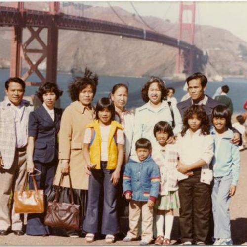 [A family posing in front of Golden Gate Bridge]