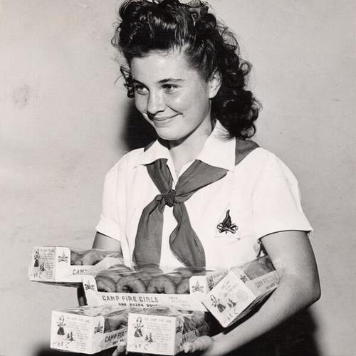 [San Francisco Camp Fire Girl Marie Seager poses as the winner of the doughnut sale]