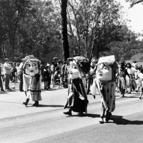 [Costumed people marching in the Golden Gate Park Centennial Parade]