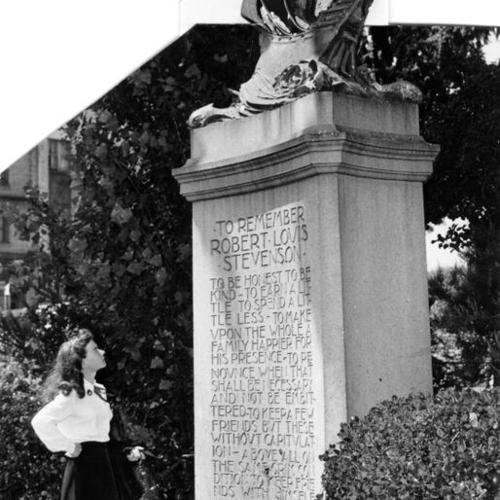 [Woman reading words inscribed on the Robert Louis Stevenson monument]