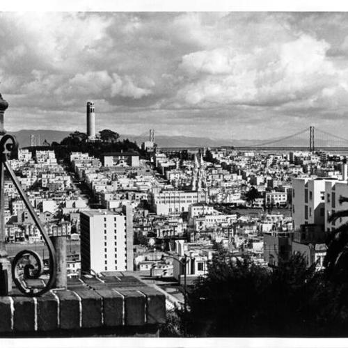 [View of North Beach district, showing Telegraph Hill and Coit Tower on left and Bay Bridge in distance]