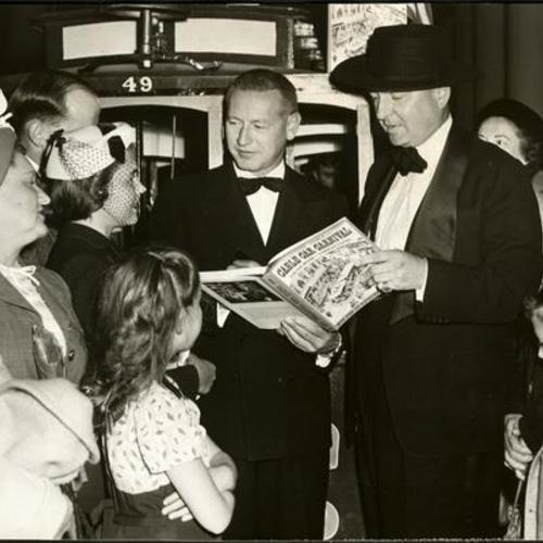 [Lucius Beebe and Charles Clegg at autograph party at the Emporium]