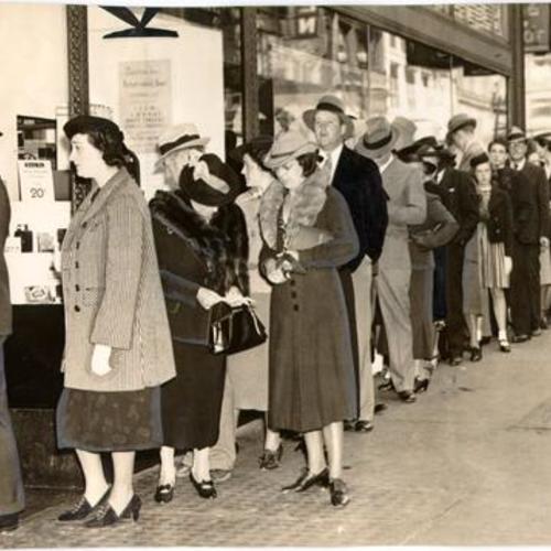 [Crowd of people lined up to buy opera tickets at Sherman & Clay box office]