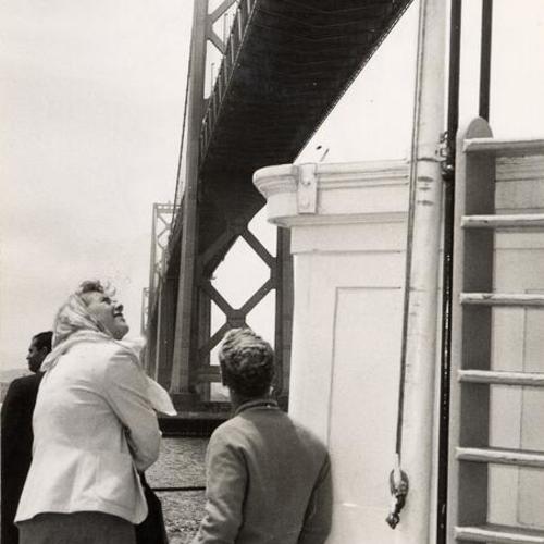 [Man and woman taking a last look from under the Bay Bridge]