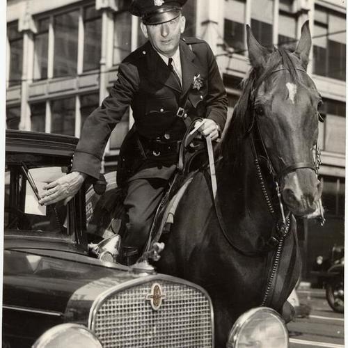 [Police officer John J. Kelly issuing parking citation ticket to a vehicle.]