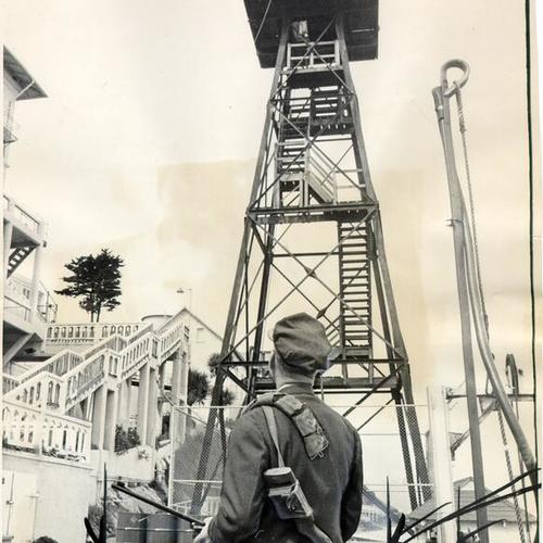 [Guard Gordon Gronzo looking at the gun tower after closing of prison on Alcatraz Island]