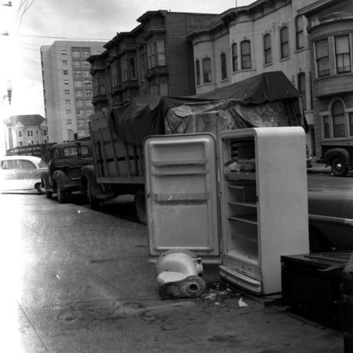 Old appliances and garbage left on sidewalk