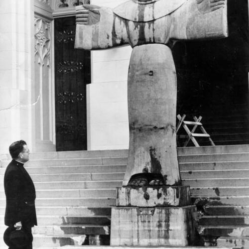 [Rev. Alvin Wagner looking at statue of Saint Francis of Assisi at the entrance to St. Francis of Assisi Church]