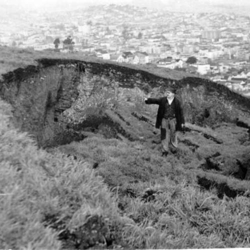 [Bernard Larsen standing at site of landslide on Bernal Heights hill]