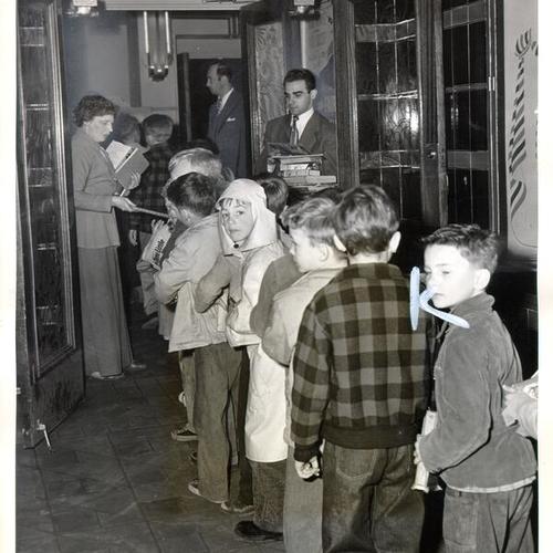 [Children lined up to see the Freedom Train movie at Noe Theater]