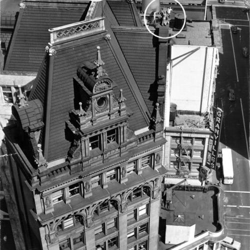 [Steeplejack Ralph Clark and two helpers standing on the roof of the Mutual Building at 704 Market Street]