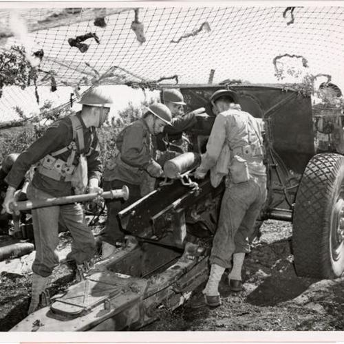 [Artillerymen loading a shell into a 155 mm howitzer during artillery practice at the Presidio]