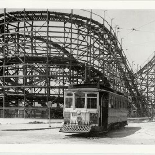 [Streetcar parked in front of the roller coaster at Playland at the Beach]