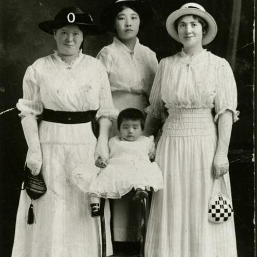 [Studio portrait with women dressed up and a child]