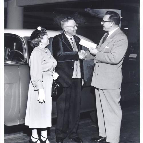[Carroll Rogers of Hale's Appliances awarding a 1955 Motoramic Chevrolet to Henry Coleman and his wife, winners of a contest sponsored by the store]