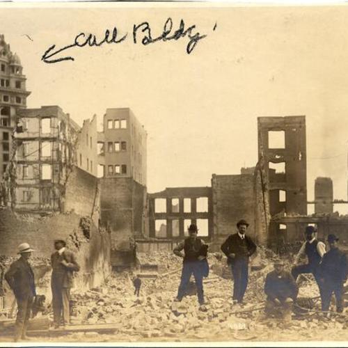 [Group of men standing amidst ruins in downtown San Francisco after the earthquake and fire of April 18, 1906, with Call Building in background]