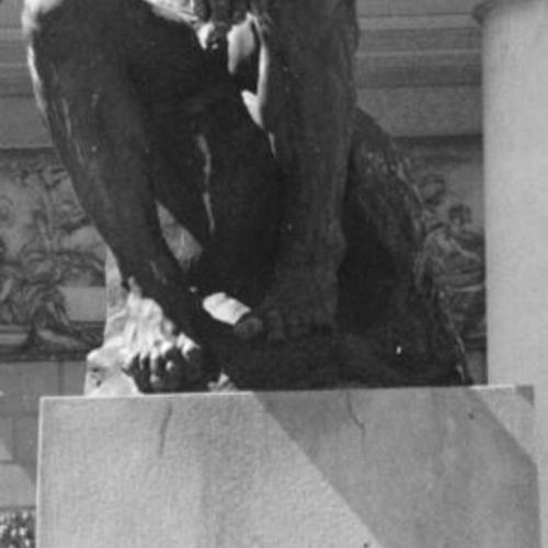 [Harlow Church Jr. sitting at the feet of Rodin's "Thinker" in front of the California Palace of the Legion of Honor]