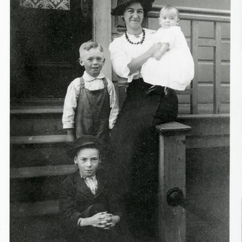[Portrait of a woman at home with her children]