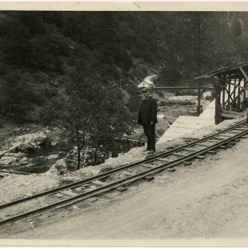 Two people at Hetch Hetchy Railroad tracks along water's edge