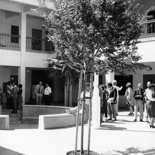 [Group of adults in a courtyard at Marshall Elementary School]