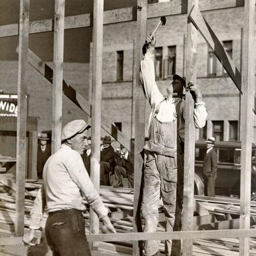 [Carpenters George Hoagland and J. A. Johnson building an architect's shack prior to construction of the Federal Building in the Civic Center]
