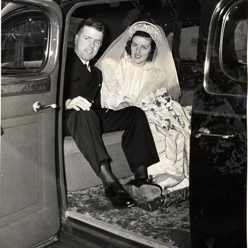 [Ensign Alfred J. Cleary Jr. and Kathleen Reilly leaving St. Monica's church after wedding ceremony]
