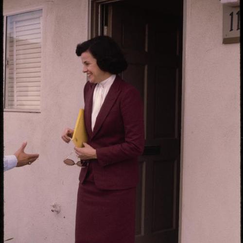 Mayor Dianne Feinstein exits Mariners Village condo to greeting audience