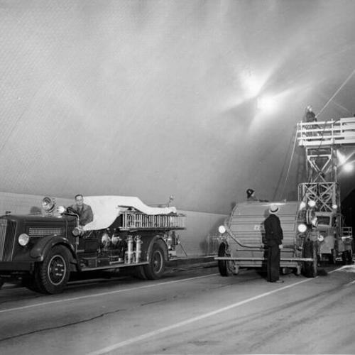 [Bay Bridge workers cleaning tile lining of Yerba Buena Island tunnel]