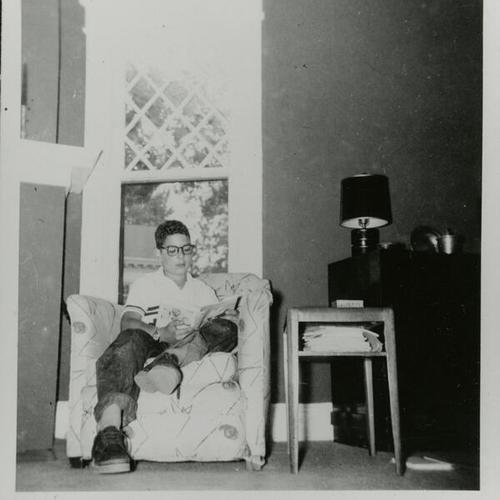 [A twelve year old boy reading at home in Glencoe, Illinois]