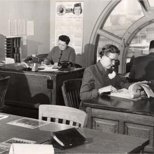 [Secretary Barbara Chernik (left corner) and four more employess working in Old Hall of Justice]