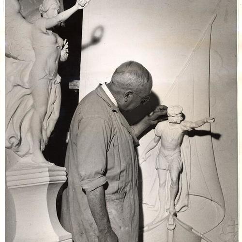 [Sculptor P. O. Tognelli working on the figure 'Discovery' for the Court of the Seven Seas, the figue on back of the artist symbolizes the Spirit of Transportation and Commnunication, Golden Gate International Exposition on Treasure Island]