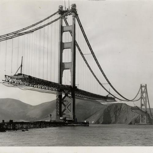 [Golden Gate Bridge deck hung from steel cables while under construction]