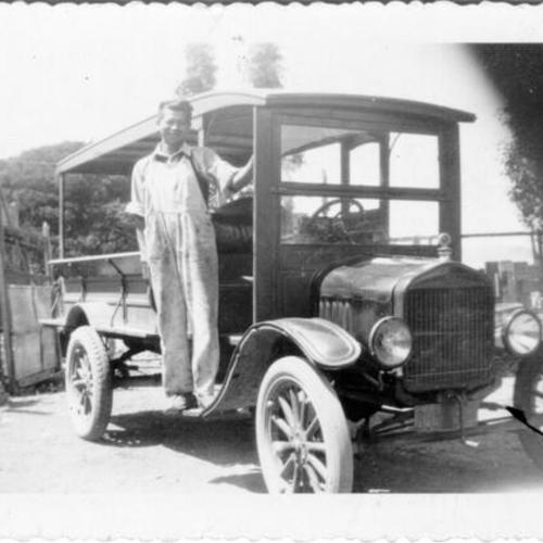 [Unidentified man posing with an automobile in Visitacion Valley]