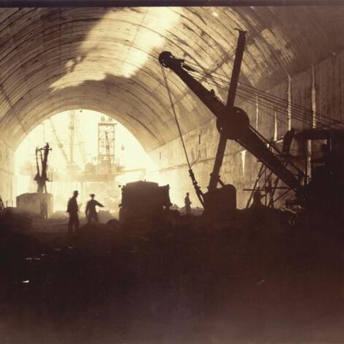[Interior view of tunnel being excavated by steam shovels on Yerba Buena Island during San Francisco-Oakland Bay Bridge construction]