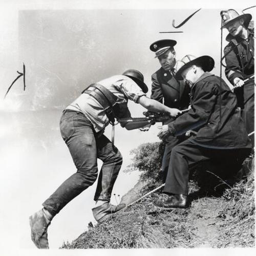[Firemen from Truck Company No. 14 rescuing a person on a steep cliff at Land's End]