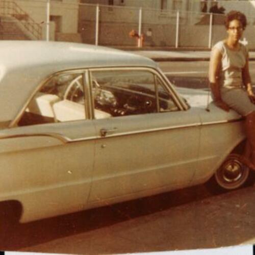 [Barbara's sister on hood of car on San Jose Avenue in front of Farragut School]