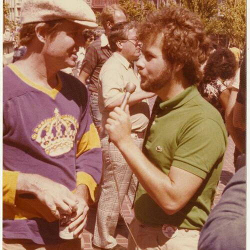 Randy Shilts (right) interviewing Armistead Maupin at Gay Freedom Day Parade, San Francisco