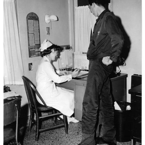 [Army nurse Lillian Dixon with malaria patient Pfc. Wm. E. Austin at Letterman General Hospital]