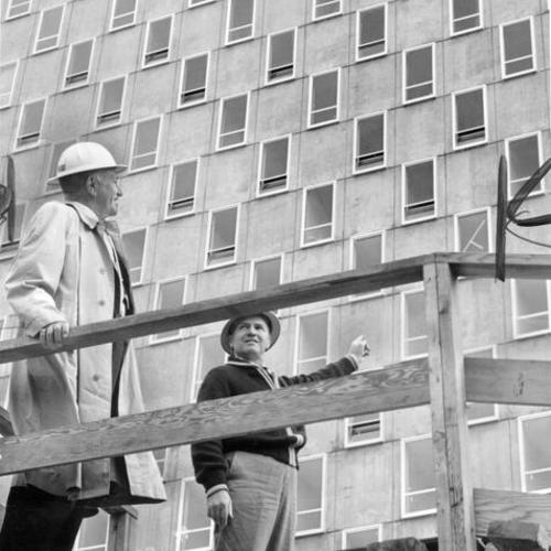 [Conrad Hilton (left) and building superintendent Arthur Trueman inspect new hotel]