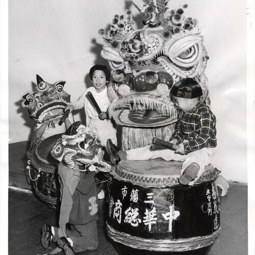 [Virginia Der, Maxine Wong, Shirley Wong and Ricky Der with costumes and drums to be used in the Chinese New Year Festival]