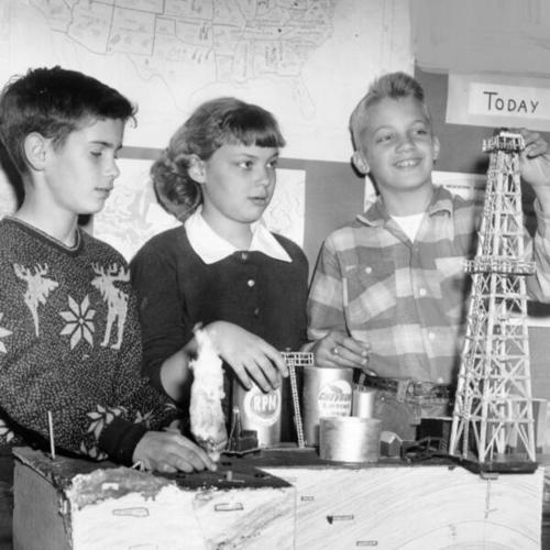 [Fifth grade students at Fairmount School with a model of an oil well]