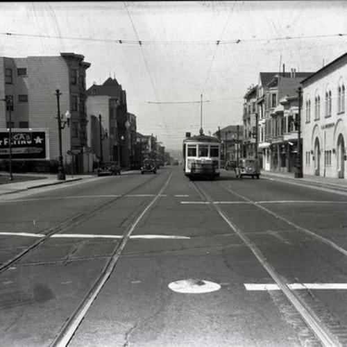[Valencia street at 25th looking north at northbound #9 line car and Southern Pacific crossing,