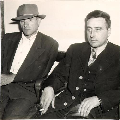 [John Russell and Roy Zocchi relaxing after a cable car they were on had a head-on collision with an automobile]