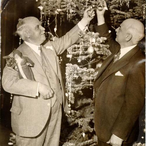 [Governor-Elect James Rolph, Jr. and Mayor Angelo J. Rossi decorating a Christmas tree]