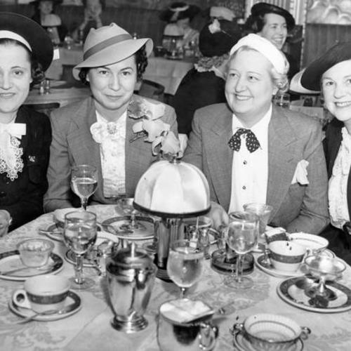 [Mrs. Roy Lynne, Mrs. W. G. Huston, Mrs. Frank More, and Mrs. J.J. Valentine seated at the Hotel Sir Francis Drake]