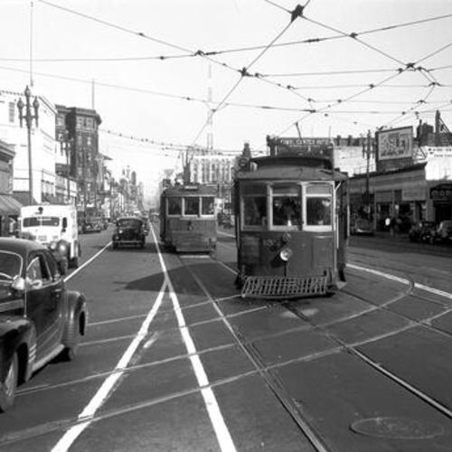 [Market street looking east at outbound #6 line car turning onto Haight street from inner tracks,