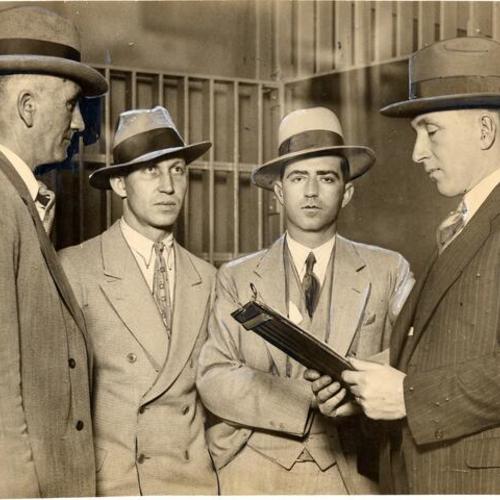 [Detective Sergeant Allen McGinn, first from left, with police officer and two civilians]