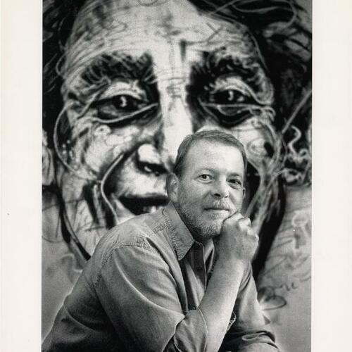 Scott Smith in front of Harvey Milk portrait by Robert Arneson