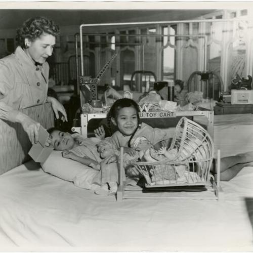 [Mrs. William Hale with two patients at Children's Hospital]