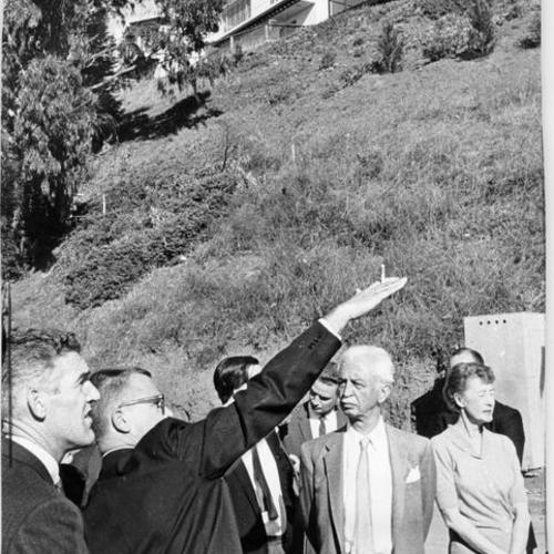 [Group of people studying possible effects of excavation at foot of Mount Davidson]